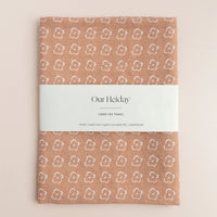 Sienna colored tea towel with a floral pattern by our heiday