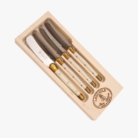 Set of four cheese spreaders with gold accents in a wooden box