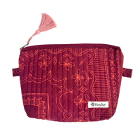 Red patterned pouch with a pink tassel