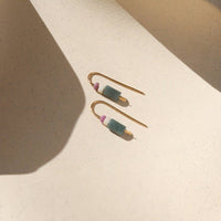 Pair of gold earrings with green and pink stones