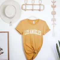 mustard colored los angeles graphic t-shirt with white text