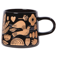 black mug with bird, flower, and leaf imprints