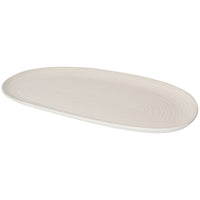 white oval serving platter with textured line design