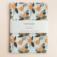 holiday linen tea towel with citrus fruits pine and hollies
