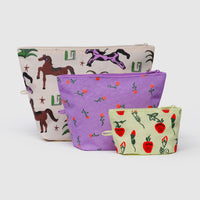 Three fabric pouches with different patterns for storing travel items