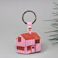 log cabin shaped pink leather keychain