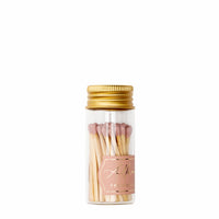 clear jar of dusty pink matches with a gold lid