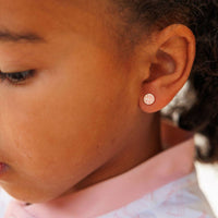 Close-up of a child wearing a small basetball