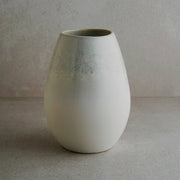 White ceramic vase with a textured surface 