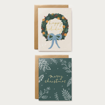 two christmas greeting cards in a box set with a wreath and foliage