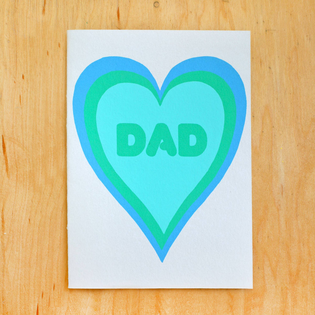 Card with a blue and green heart-shaped design and 'DAD' text 