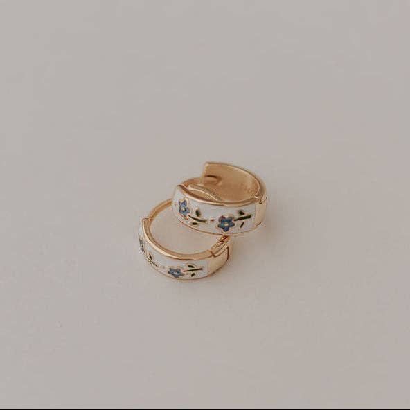 Pair of gold hoop earrings with floral designs 