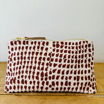 white fabric clutch with red spotted pattern