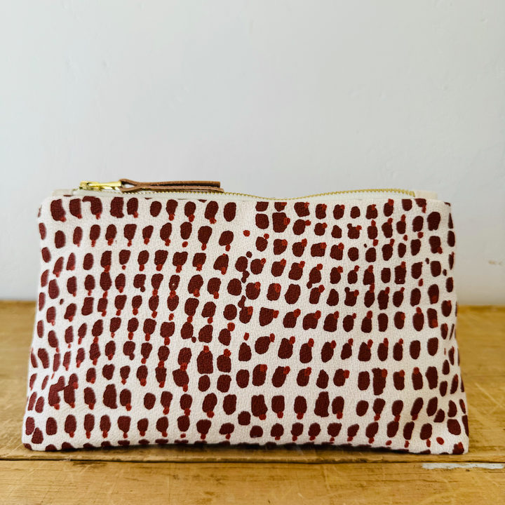 white fabric clutch with red spotted pattern