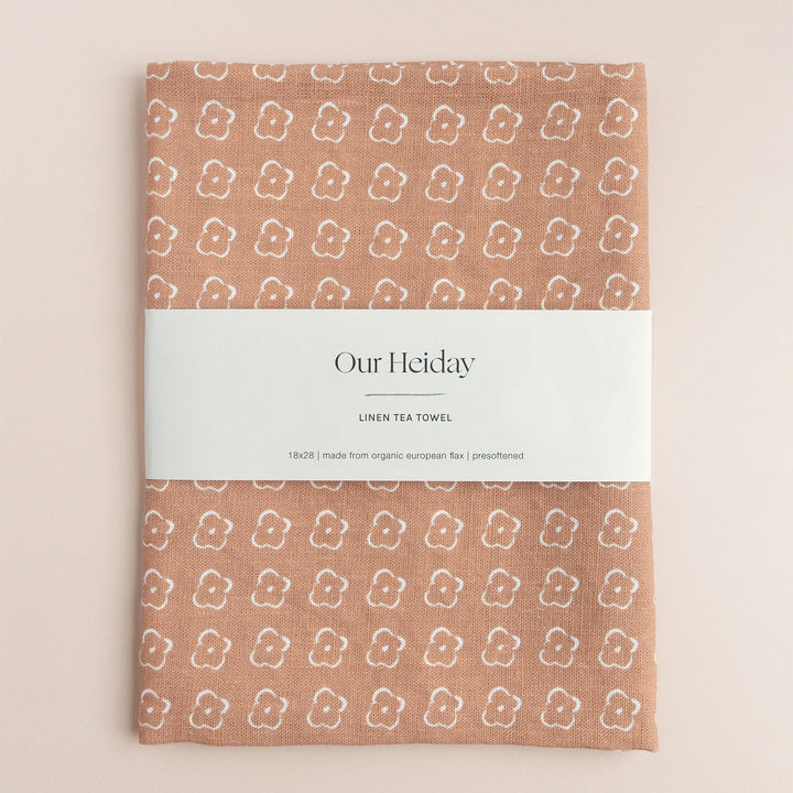 Sienna colored tea towel with a floral pattern by our heiday