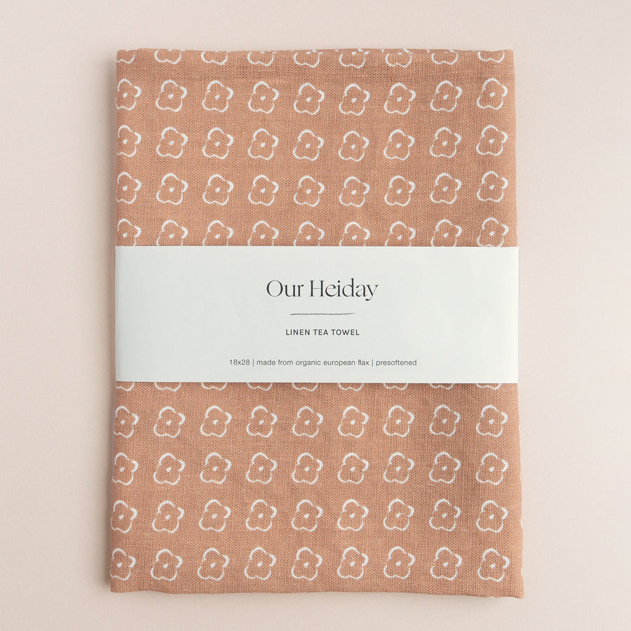 Sienna colored tea towel with a floral pattern by our heiday