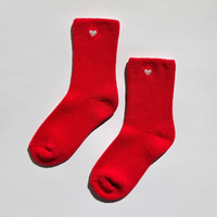 Pair of red fuzzy socks with embroidered hearts