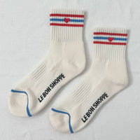 White socks with red, blue, and white stripes and an embroidered heart