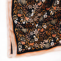 black silk scarf with pops of orange, salmon, and cream colors