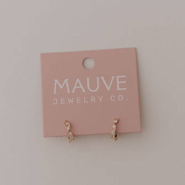 pair of gold huggie hoop earrings with oval cut cubic zirconia 