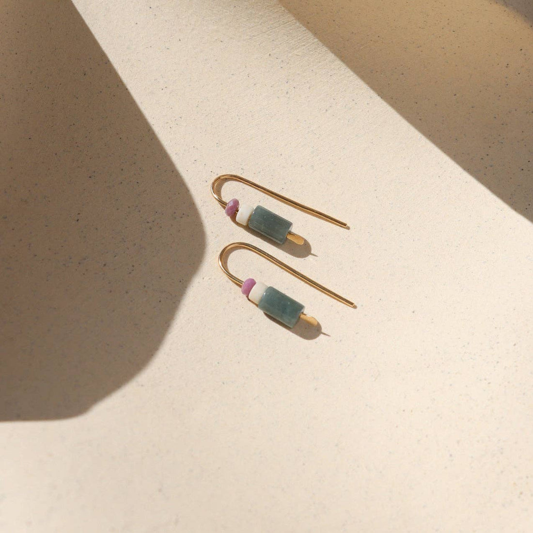 Pair of gold earrings with green and pink stones 