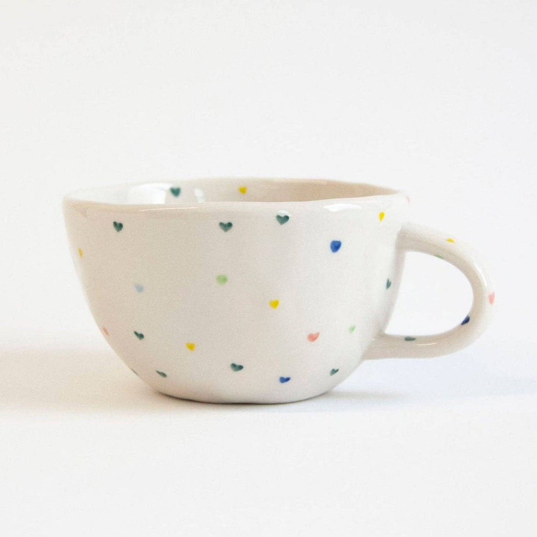 Ceramic mug with colorful speckles on a white background