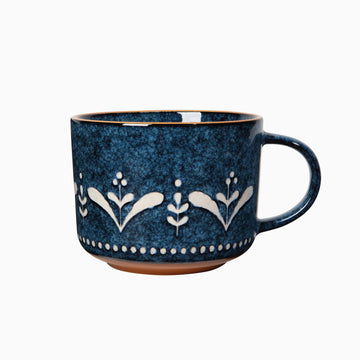 a midnight blue mug with white nature pattern 