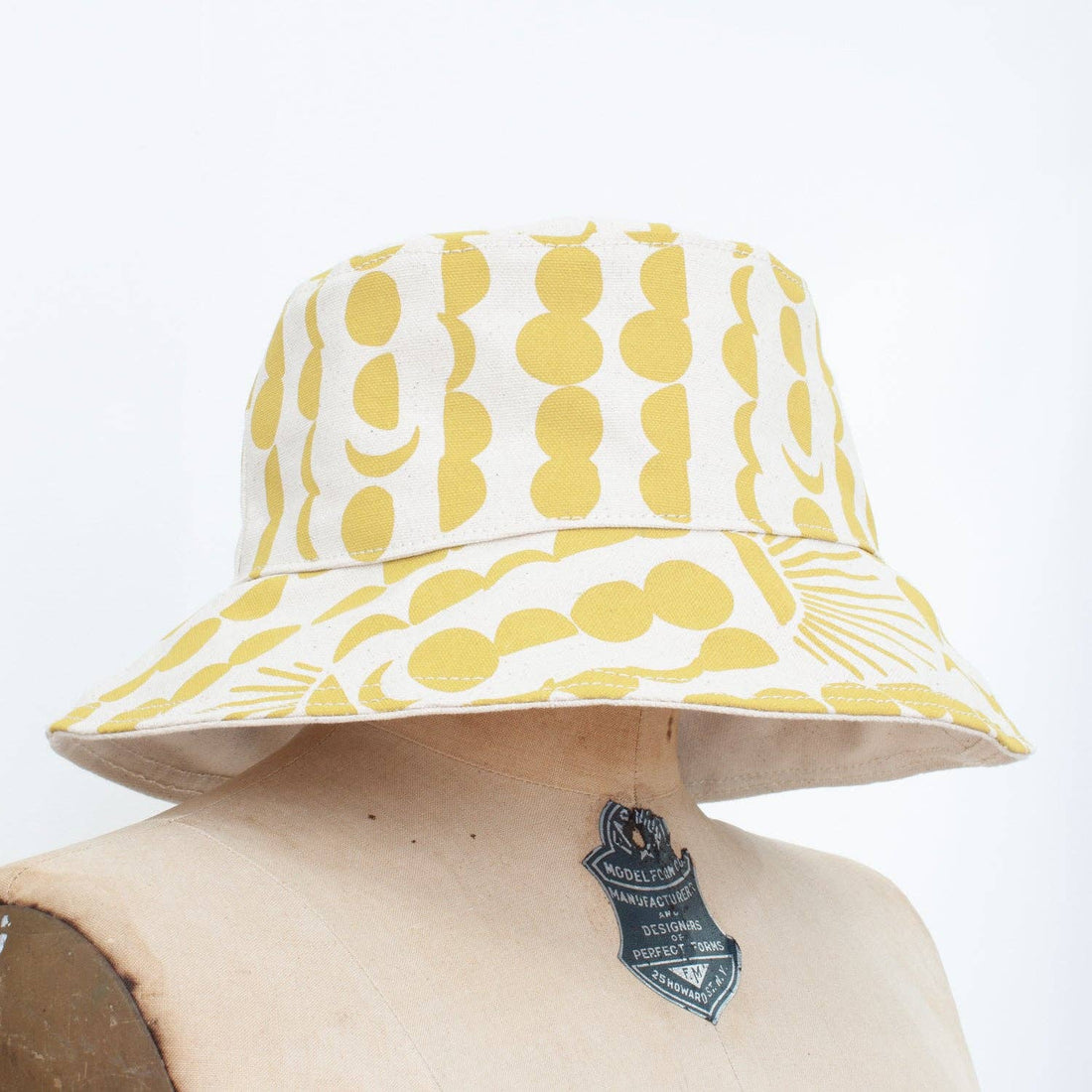 yellow sun and moon patterned white bucket hat