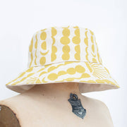 yellow sun and moon patterned white bucket hat