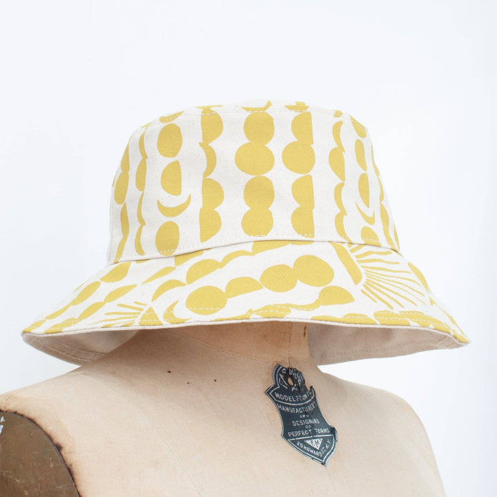 yellow sun and moon patterned white bucket hat