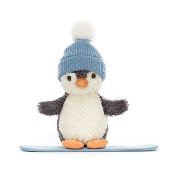 plush penguin toy wearing a blue knitted hat on a blue snowboard
