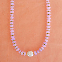 purple beaded necklace with a mother of pearl 