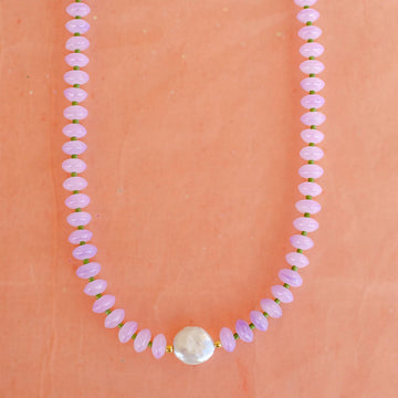 purple beaded necklace with a mother of pearl 