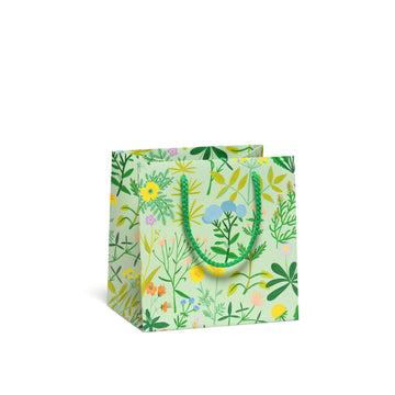 small gift bag with green base and soft colored flowers