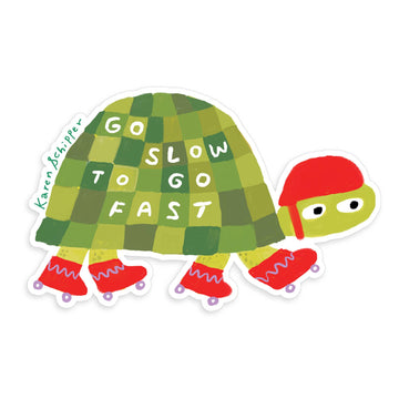 Sticker of a turtle with a checkered shell and red helmet, featuring the text 'Go slow to go fast'.
