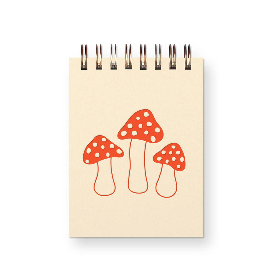 mini notebook with cream base and red mushrooms