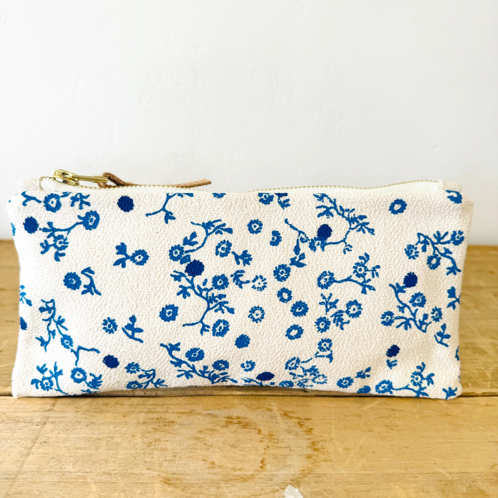 white and blue floral patterned pencil pouch 