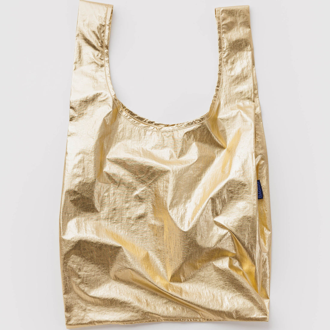 Gold metallic reusable bag on a light gray background