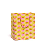 Yellow and pink patterned gift bag with sunbursts