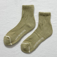 sage colored womens socks with off white  stripe across the toe box