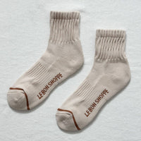 beige socks with a brown stripe on the toe box