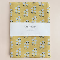 Yellow linen tea towel with floral pattern 