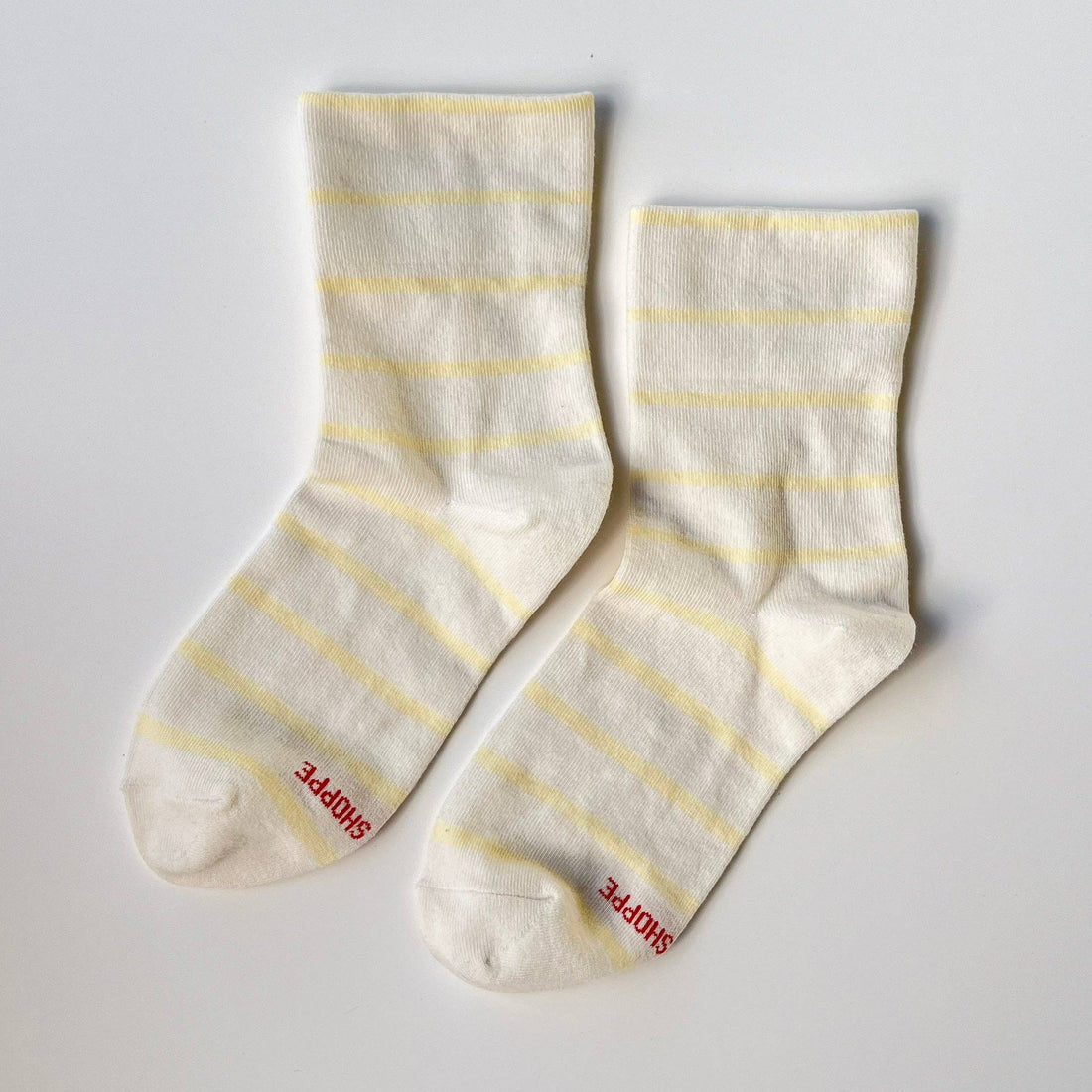 Pair of white socks with yellow stripes 