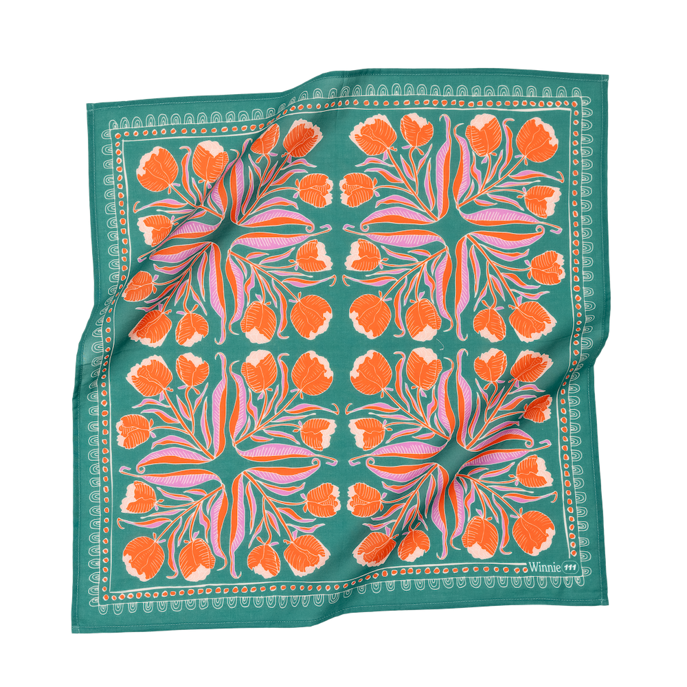 Floral patterned scarf with orange flowers on green fabric 