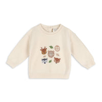 beige sweater with woodland animals embroidered on the front 
