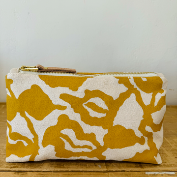 yellow and white patterned fabric clutch