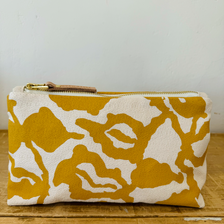 yellow and white patterned fabric clutch