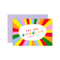a colorful mini black note card with "you are amazing" text 