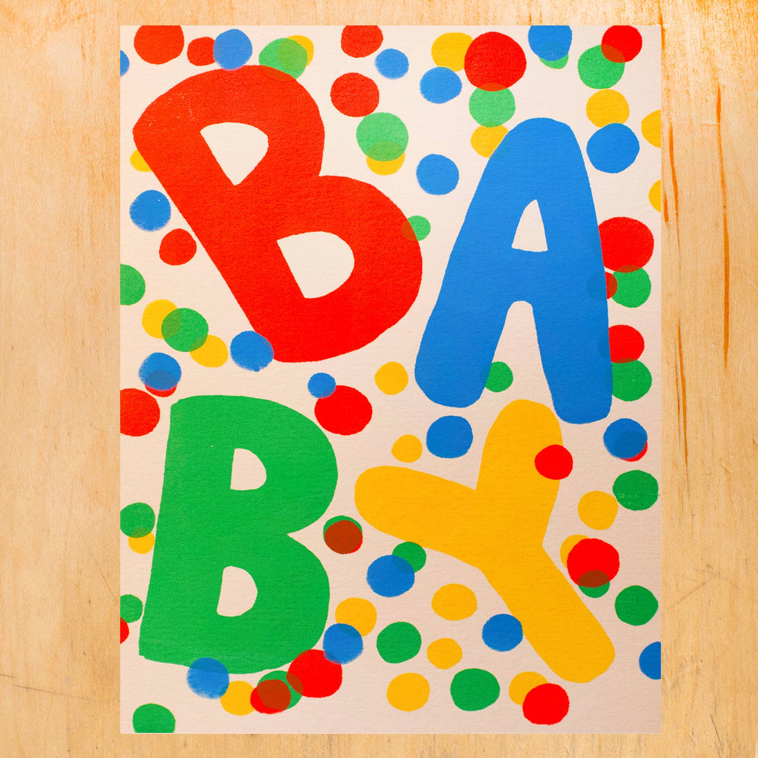 a colorful baby card with dots and "BABY" text 