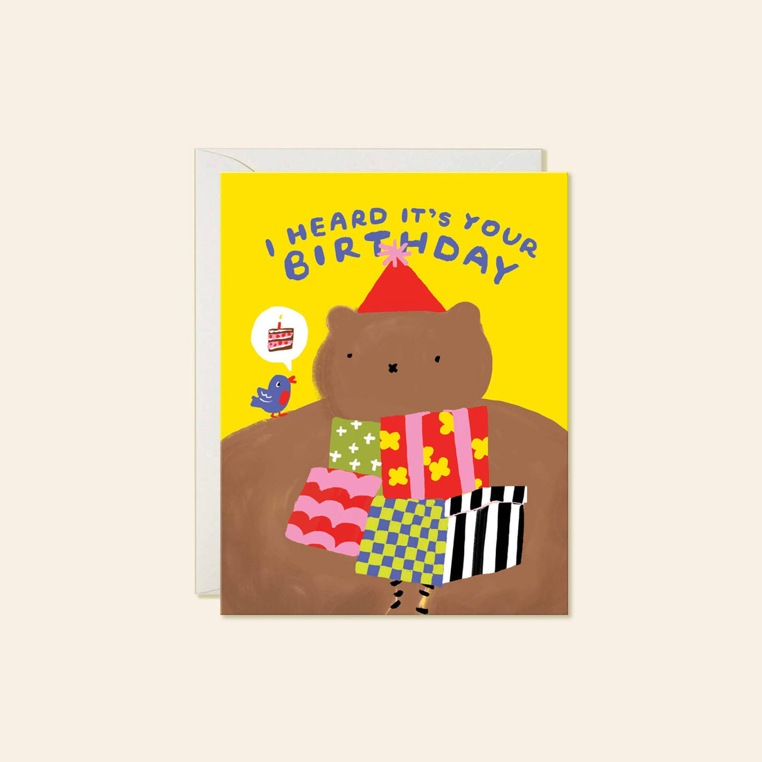 A greeting card featuring a cartoon brown bear wearing a red party hat and colorful patterned clothing, with the text 'I HEARD IT'S YOUR BIRTHDAY' 